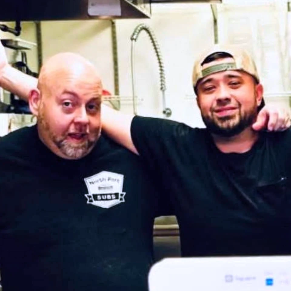 Two members of the North Port Subs family photographed inside the shop